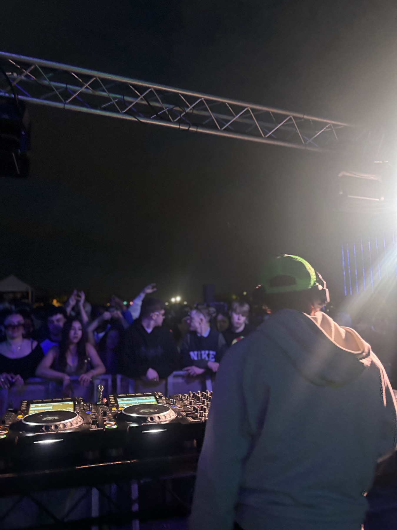 A live music set viewed from behind the decks